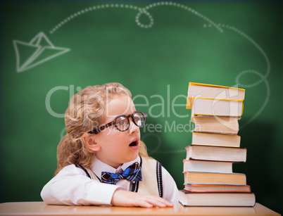 Composite image of surprise pupil looking at books