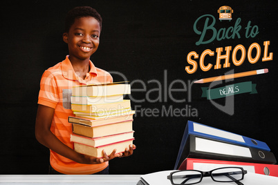 Composite image of portrait of cute boy carrying books in librar