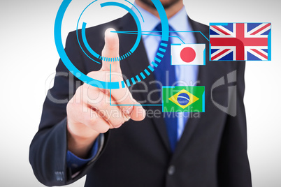 Composite image of businessman pointing his finger at camera