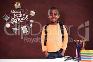 Composite image of cute elementary pupil smiling at camera