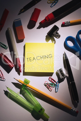 Teaching against students table with school supplies