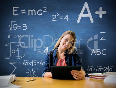 Composite image of student studying in the library with tablet