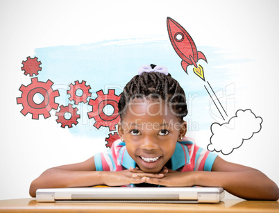 Composite image of smiling pupil sitting at her desk