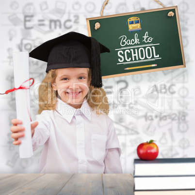 Composite image of smiling schoolgirl with graduation cap and ho