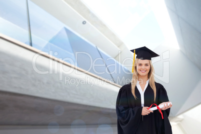 Composite image of full length shot of a graduate holding a degr