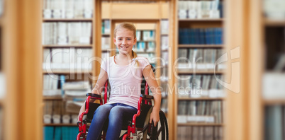 Composite image of girl sitting in wheelchair in school corridor