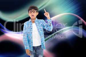 Composite image of cute boy pointing up with finger