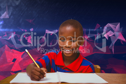 Composite image of pupil working at desk