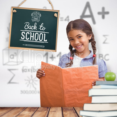 Composite image of cute pupil smiling at camera during class pre