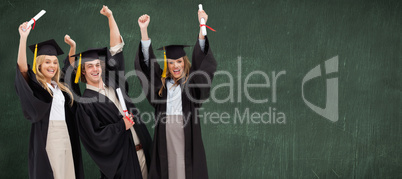 Composite image of three students in graduate robe raising their