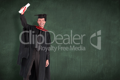 Composite image of smiling handsome boy showing his diploma to t