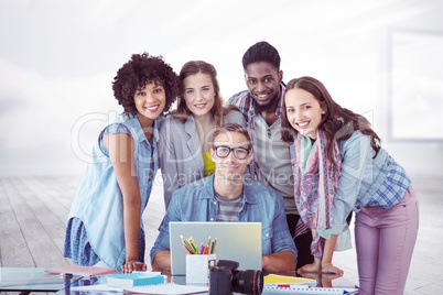 Composite image of fashion students working as a team