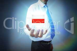 Composite image of businessman holding hand out