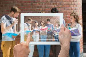 Composite image of hand holding tablet pc