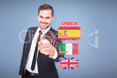 Composite image of happy businessman pointing at camera