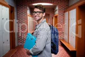 Composite image of student smiling at camera in library