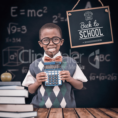 Composite image of happy pupil with calculator