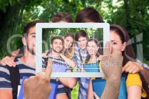 Composite image of hand holding tablet pc