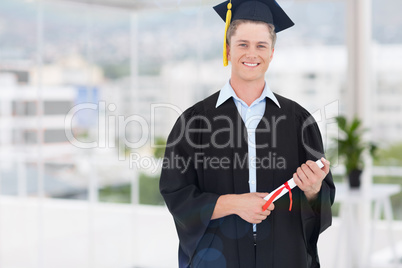 Composite image of blonde student in graduate robe holding a dip