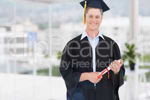 Composite image of blonde student in graduate robe holding a dip