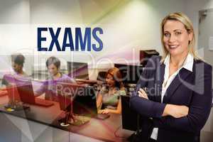Exams against computer teacher smiling at camera with arms cross
