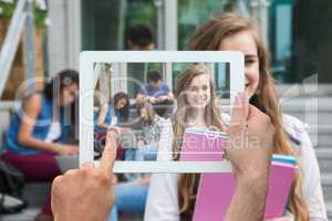 Composite image of hand holding tablet pc