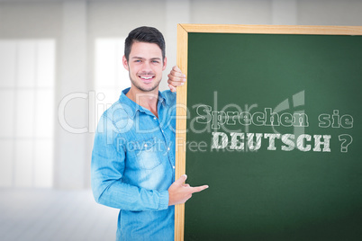 Composite image of happy man pointing to card