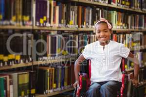 Composite image of girl sitting in wheelchair in school corridor