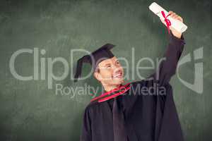 Composite image of happy attractive boy celebrating his graduati