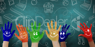 Composite image of hands with colourful smiley faces