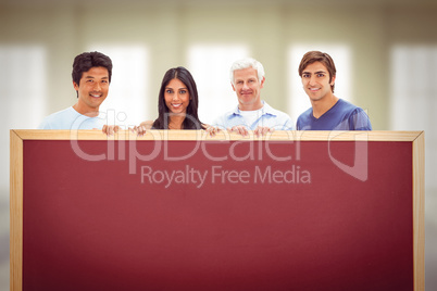 Composite image of people in jeans holding a big sign