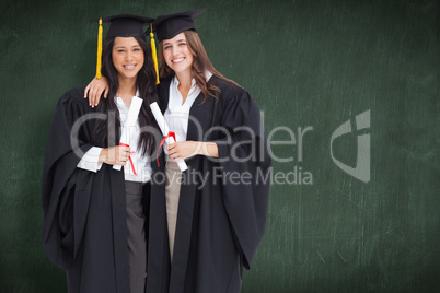 Composite image of two women embracing each other after they gra