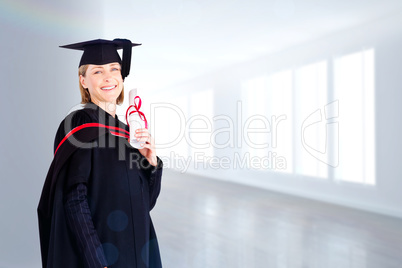 Composite image of confident graduated woman looking at the came