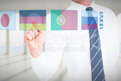 Composite image of businessman pointing with his finger