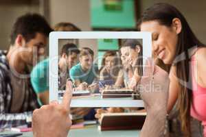 Composite image of hand holding tablet pc