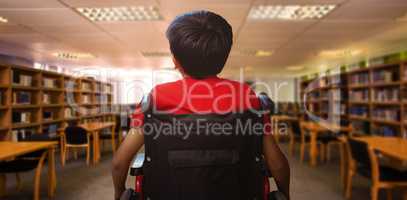 Composite image of rear view of boy sitting in wheelchair