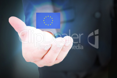 Composite image of businessman holding out his hand