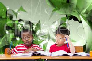 Composite image of cute pupils writing at desk in classroom
