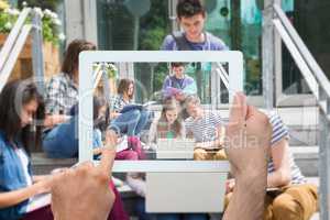 Composite image of hand holding tablet pc