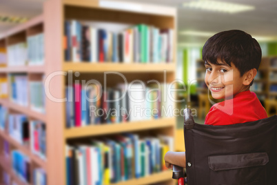 Composite image of boy sitting in wheelchair in school