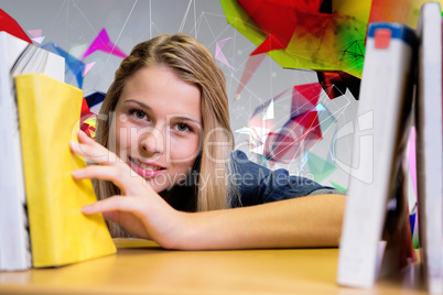 Composite image of pretty student in the library