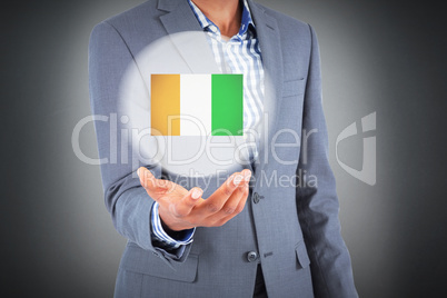 Composite image of businessman holding hand out