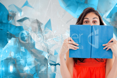 Composite image of portrait of a student hiding behind a blue bo