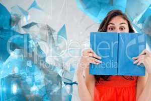 Composite image of portrait of a student hiding behind a blue bo