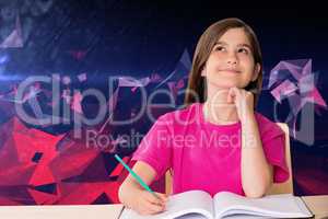 Composite image of cute pupil working at her desk