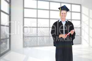 Composite image of a male graduate with his degree in hand