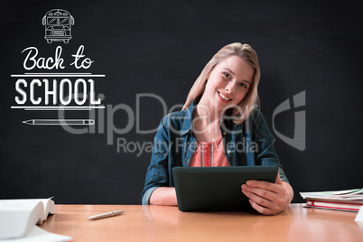 Composite image of student studying in the library with tablet