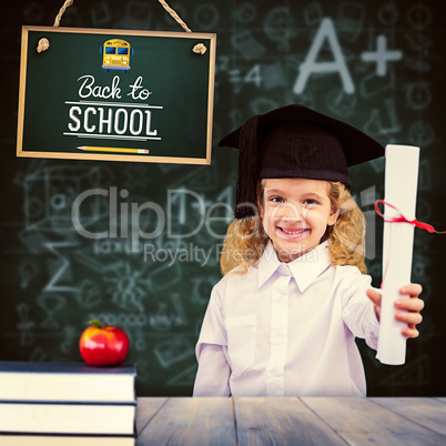 Composite image of smiling schoolgirl with graduation cap and ho