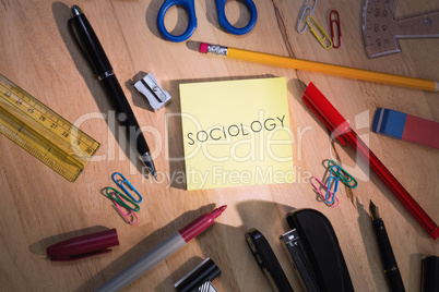 Sociology against students table with school supplies