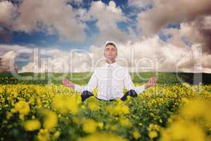 Composite image of zen businessman meditating in lotus pose